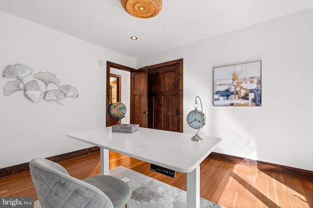 home office featuring baseboards, wood finished floors, and recessed lighting