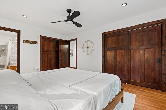 bedroom featuring light wood-type flooring, recessed lighting, a ceiling fan, and ensuite bathroom