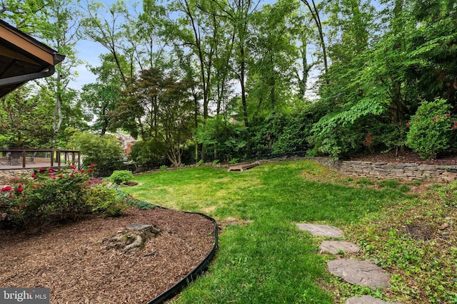 view of green lawn with a deck