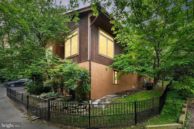 view of home's exterior featuring fence and stucco siding
