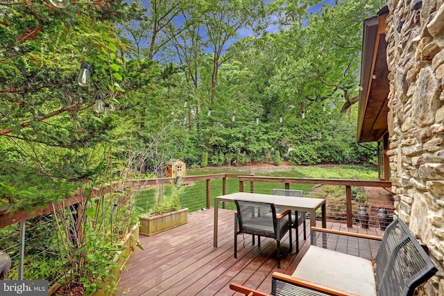 wooden deck with outdoor dining space