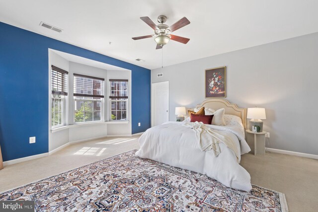 bedroom with carpet floors, baseboards, and visible vents