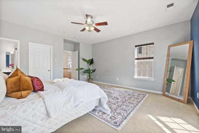 bedroom featuring carpet flooring, a ceiling fan, baseboards, and visible vents