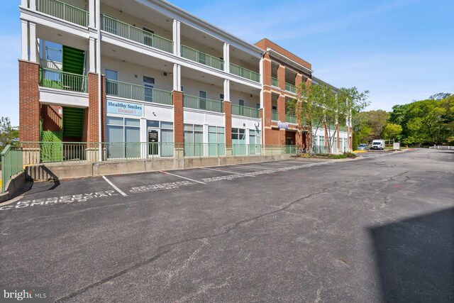 view of building exterior with uncovered parking