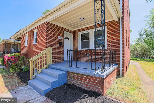 view of exterior entry with brick siding
