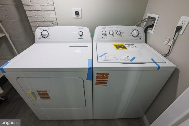 laundry area featuring washing machine and clothes dryer, laundry area, and dark wood-style floors
