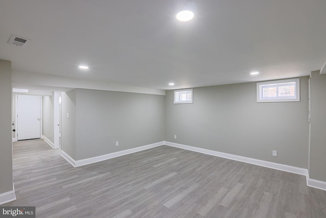 basement featuring recessed lighting, visible vents, and light wood finished floors
