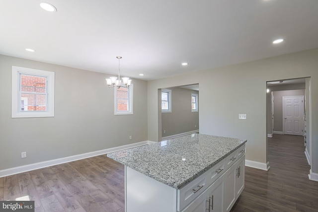 kitchen with plenty of natural light, dark wood-style floors, and white cabinetry