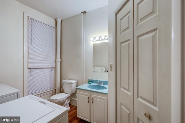 bathroom featuring vanity, wood finished floors, and toilet