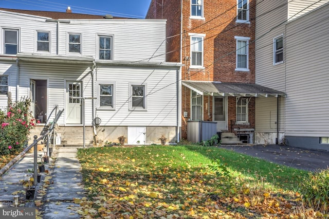 exterior space featuring entry steps and a yard