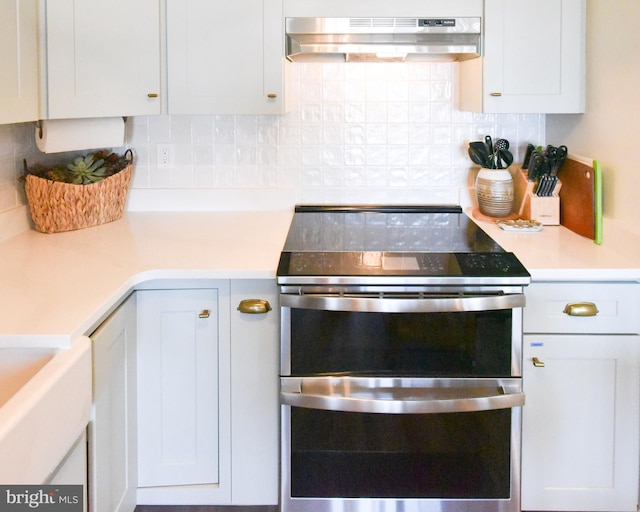 3801 Atlantic Ave Unit 105, Ocean City, MD 21842 - kitchen featuring under cabinet range hood, range with two ovens, backsplash, and light countertops