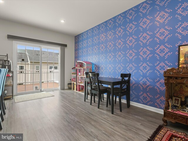 dining area with wallpapered walls, wood finished floors, baseboards, and recessed lighting