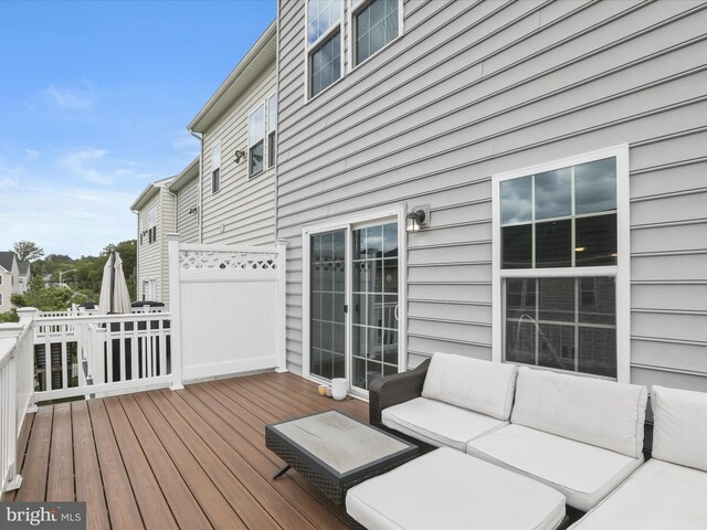 wooden terrace featuring an outdoor living space