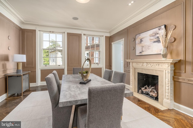 dining space featuring crown molding, baseboards, and a fireplace