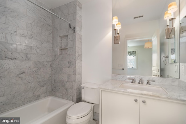 bathroom with visible vents, shower / bathtub combination, toilet, and vanity
