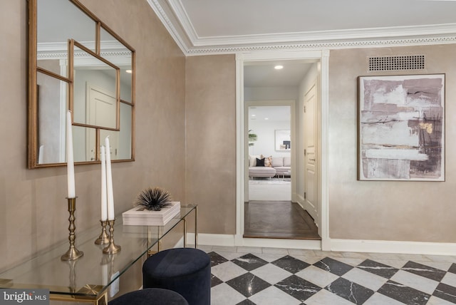 corridor with crown molding, baseboards, and visible vents