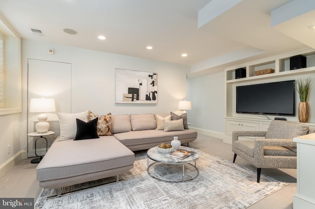 living room with carpet floors, baseboards, and visible vents