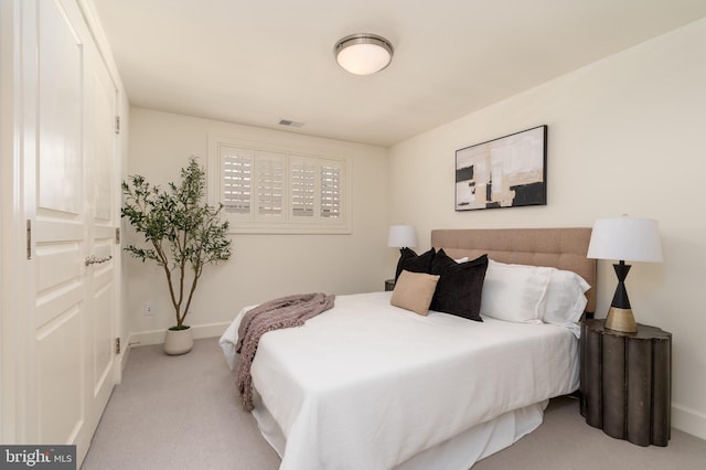 bedroom with light colored carpet, baseboards, and visible vents