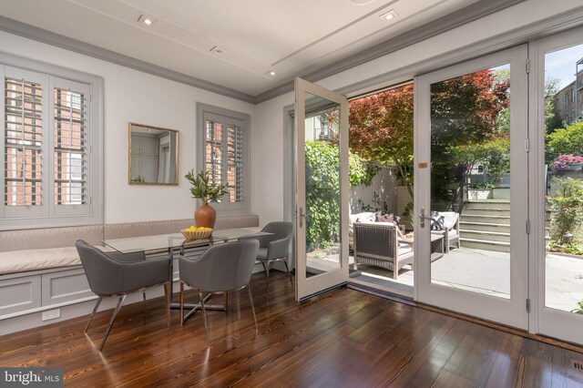 dining room with ornamental molding and dark wood finished floors