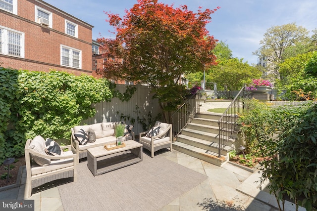 view of patio / terrace with an outdoor living space and fence
