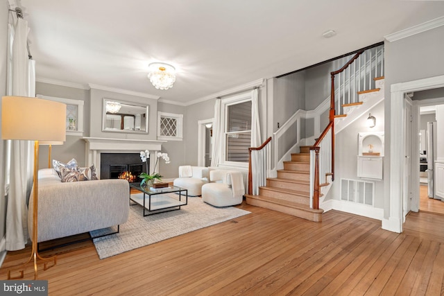 6763 25th St N, Arlington, VA 22213 - living area featuring hardwood / wood-style flooring, stairway, a lit fireplace, ornamental molding, and baseboards