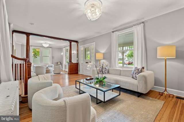 6763 25th St N, Arlington, VA 22213 - living room with decorative columns, ornamental molding, and light wood-style floors