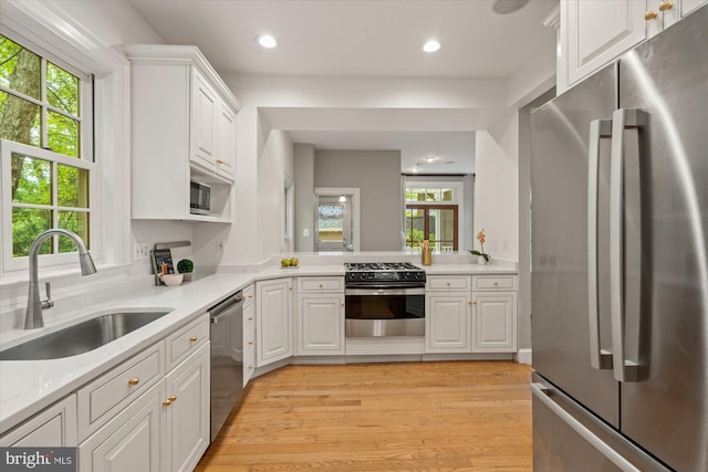 6763 25th St N, Arlington, VA 22213 - kitchen featuring stainless steel appliances, a sink, healthy amount of natural light, white cabinetry, and recessed lighting