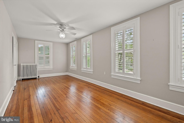 6763 25th St N, Arlington, VA 22213 - empty room with radiator, baseboards, hardwood / wood-style flooring, a ceiling fan, and healthy amount of natural light
