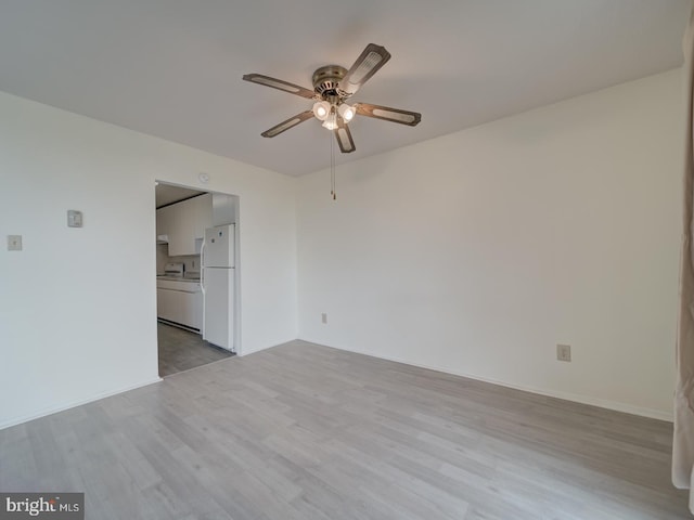 empty room with a ceiling fan and wood finished floors