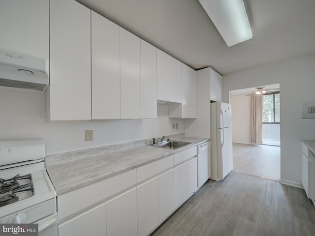 kitchen featuring a sink, white appliances, light countertops, light wood-style flooring, and white cabinetry