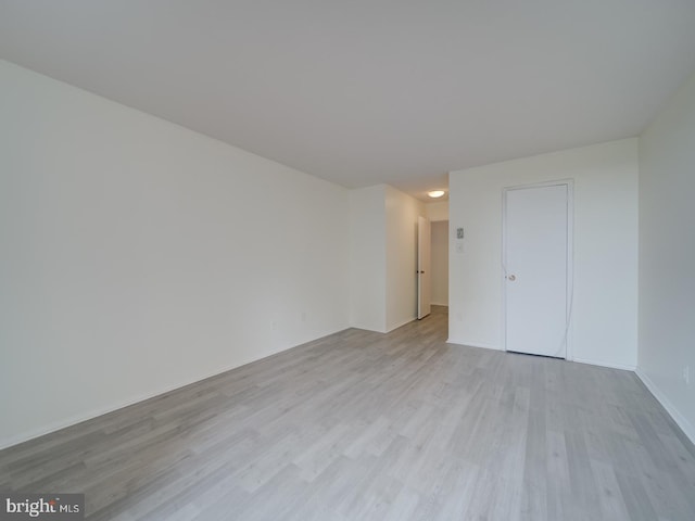 spare room with wood finished floors