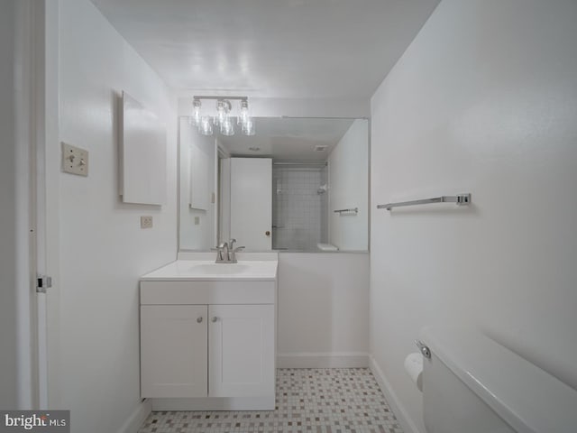 bathroom with baseboards, tile patterned floors, toilet, and tiled shower