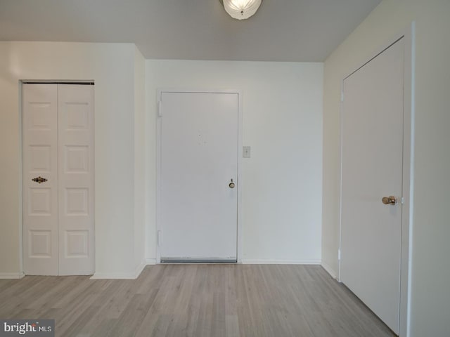 entrance foyer with baseboards and wood finished floors