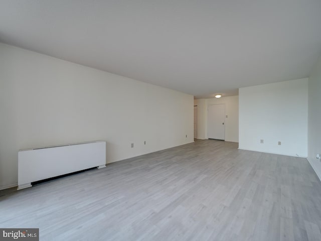 unfurnished living room featuring wood finished floors