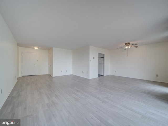 spare room featuring a ceiling fan and light wood-style flooring