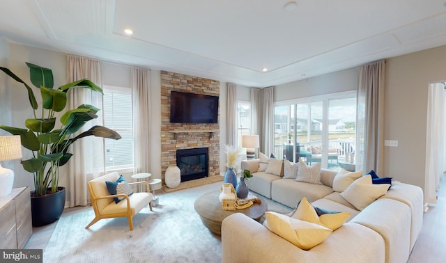 33833 Joel Ln, Lewes, DE 19958 - living area with a fireplace, a tray ceiling, recessed lighting, and wood finished floors