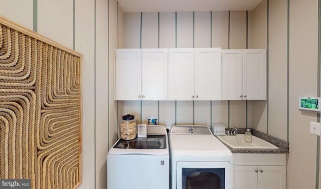 33833 Joel Ln, Lewes, DE 19958 - laundry area featuring a sink, a decorative wall, cabinet space, and washing machine and clothes dryer