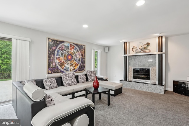 carpeted living area with a high end fireplace and recessed lighting