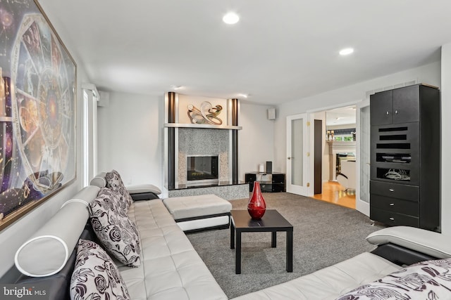 living area featuring carpet, a fireplace, and recessed lighting