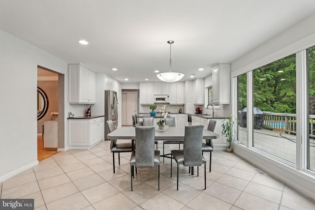 dining room with light tile patterned floors, recessed lighting, and baseboards