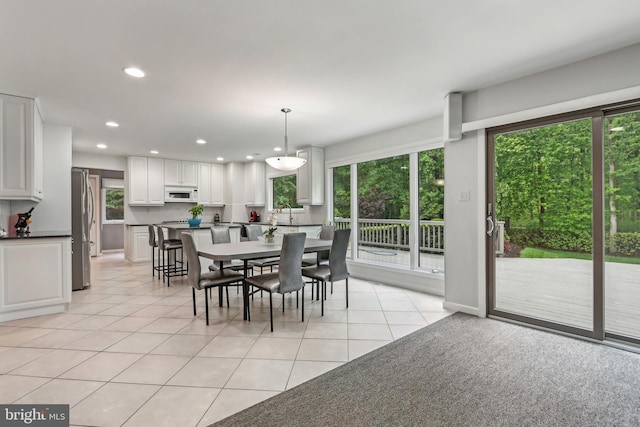dining space with plenty of natural light, recessed lighting, and light tile patterned floors