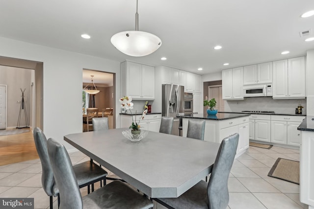 dining room featuring light tile patterned flooring and recessed lighting