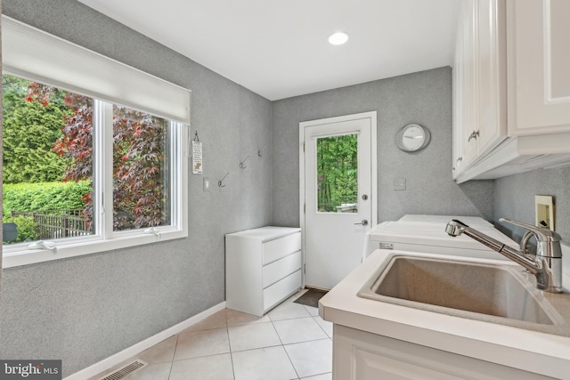laundry room featuring cabinet space, light tile patterned floors, washer / dryer, a textured wall, and recessed lighting