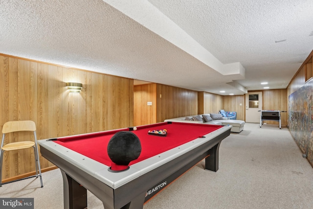 game room featuring pool table, wood walls, a textured ceiling, and carpet floors