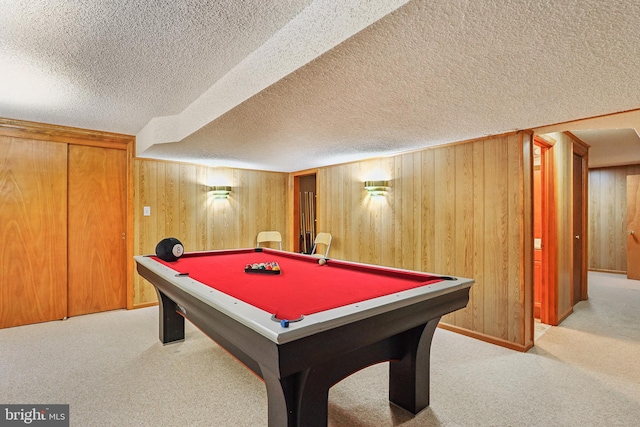 rec room featuring carpet floors, wood walls, pool table, and a textured ceiling