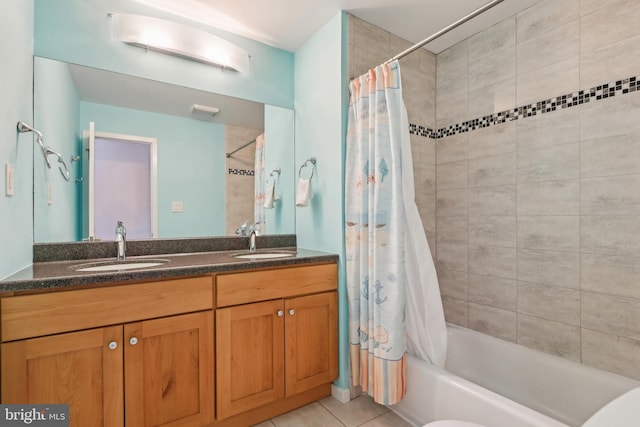 bathroom with shower / bath combination with curtain, double vanity, and tile patterned floors