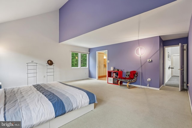 carpeted bedroom featuring baseboards and high vaulted ceiling