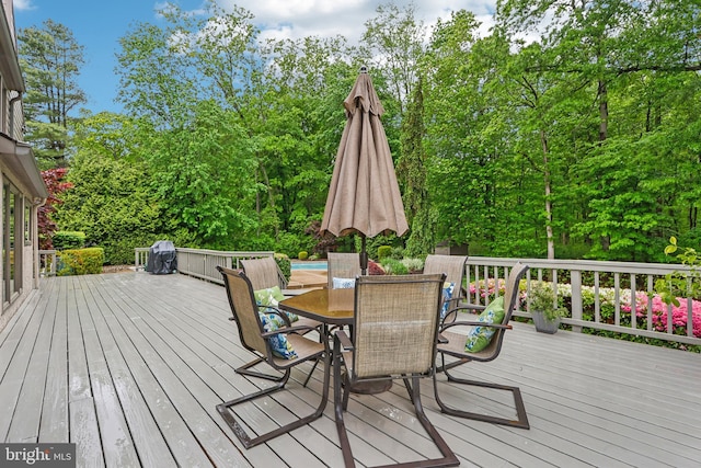 wooden deck featuring outdoor dining space