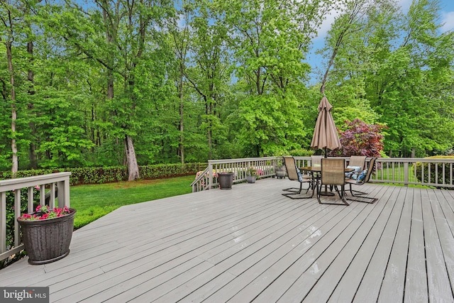 wooden deck featuring a yard and outdoor dining area