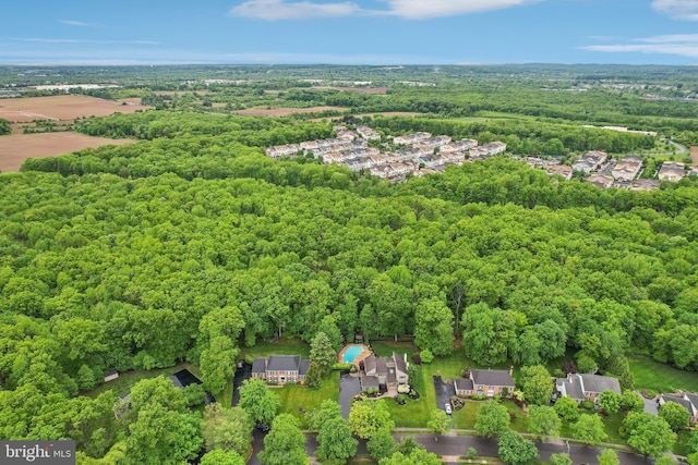 aerial perspective of suburban area with a heavily wooded area